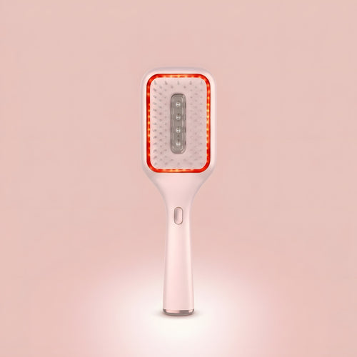 Elara Red Light Brush shown upright, white paddle brush with a glowing red LED ring around the bristles.